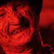 A red-toned Freddy Krueger smiles in Freddy vs Jason.